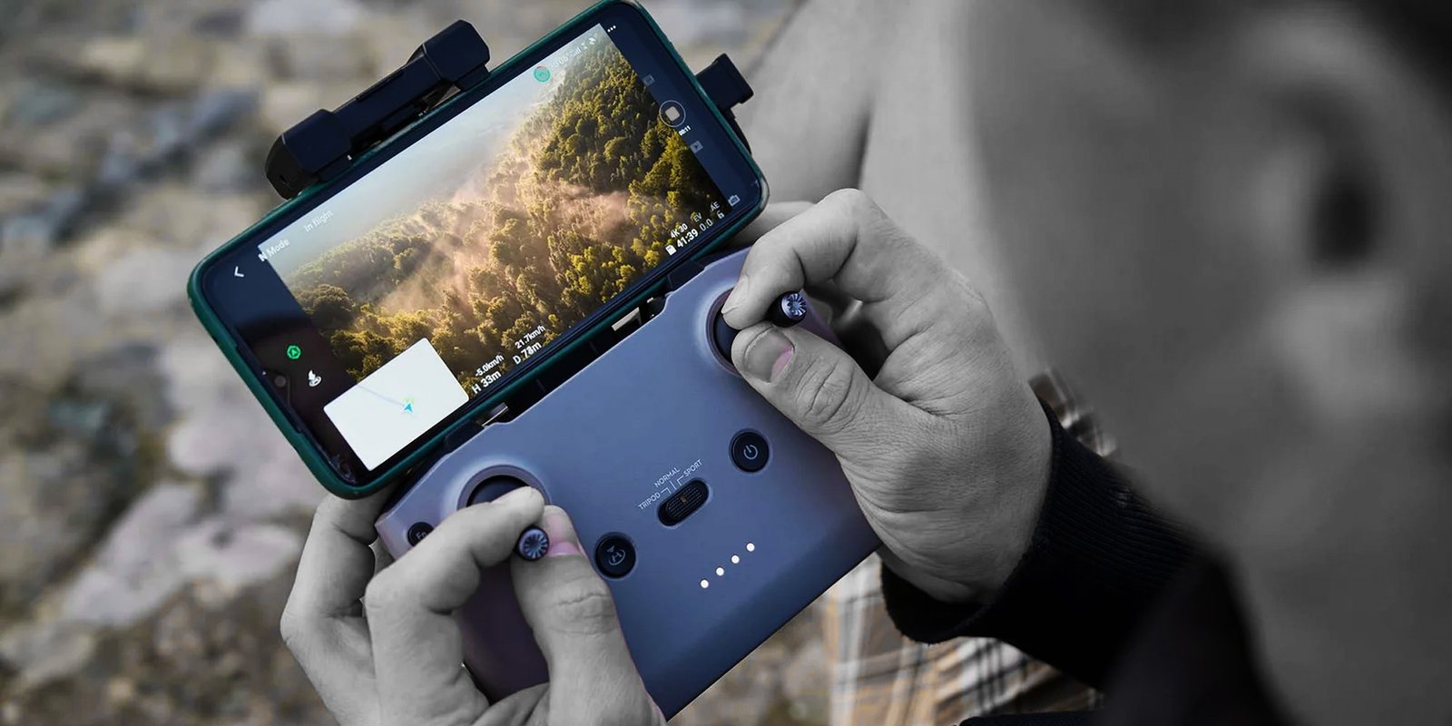 man-operating-drone-using-remote-controller-1